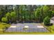 Full basketball court with black fencing and tall trees in the background, suitable for recreation and exercise at 379 Villa Rosa Way, Temple, GA 30179