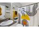 Stylish bathroom with modern vanity, framed art, and shower with decorative curtain at 379 Villa Rosa Way, Temple, GA 30179