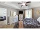 Light-filled main bedroom features tray ceilings, neutral paint, and an en-suite bath at 379 Villa Rosa Way, Temple, GA 30179