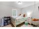 Bright bedroom features a bed, accent chair, and window at 379 Villa Rosa Way, Temple, GA 30179