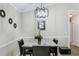 Cozy dining room featuring a marble table, modern chandelier, and neutral color palette at 379 Villa Rosa Way, Temple, GA 30179