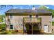 Back exterior view showing a well-maintained yard and a wooden deck at 379 Villa Rosa Way, Temple, GA 30179