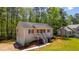 Traditional-style home with a welcoming porch and a well-maintained lawn nestled in a wooded setting at 379 Villa Rosa Way, Temple, GA 30179