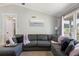 Comfortable living room showcases a gray sectional, a window that provides natural light, and neutral paint at 379 Villa Rosa Way, Temple, GA 30179