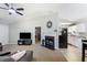 Open-concept living room with a fireplace seamlessly connected to the kitchen area at 379 Villa Rosa Way, Temple, GA 30179