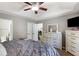 Serene main bedroom featuring tray ceiling, dresser, and view into dining room at 379 Villa Rosa Way, Temple, GA 30179