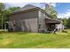 Spacious backyard featuring a well-manicured lawn, a covered patio, and outdoor seating at 415 Paynes Lake Rd, Carrollton, GA 30116