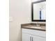 Modern bathroom vanity with a gray countertop, white cabinets, and a sleek, framed mirror at 415 Paynes Lake Rd, Carrollton, GA 30116