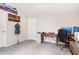 Bright home office features a desk, sewing mannequin, computer station, and a vaulted ceiling at 415 Paynes Lake Rd, Carrollton, GA 30116