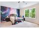 Bedroom featuring a themed wall, large window, and ceiling fan, perfect for relaxation and personalization at 415 Paynes Lake Rd, Carrollton, GA 30116