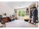 Home office with a desk, dresser and decor with natural light from the large window with views of the backyard at 415 Paynes Lake Rd, Carrollton, GA 30116