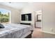 Bedroom featuring a large window and a view of a bathroom with a granite sink, a black mirror, and white cabinets at 415 Paynes Lake Rd, Carrollton, GA 30116
