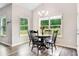 Inviting dining area with a round table, black chairs, two windows, and pendant lighting at 415 Paynes Lake Rd, Carrollton, GA 30116