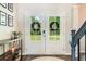 Welcoming entryway with double glass doors, hardwood floors, and stylish decor at 415 Paynes Lake Rd, Carrollton, GA 30116