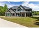 Stately two-story home featuring manicured lawn, detailed gables, and a welcoming front porch at 415 Paynes Lake Rd, Carrollton, GA 30116