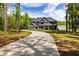 Spacious home with a long driveway surrounded by lush greenery and blue sky at 415 Paynes Lake Rd, Carrollton, GA 30116