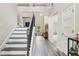 Elegant foyer with hardwood floors, staircase, and an open view to the living area at 415 Paynes Lake Rd, Carrollton, GA 30116