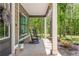 Relaxing front porch featuring rocking chairs, natural wood accents, and views of surrounding trees at 415 Paynes Lake Rd, Carrollton, GA 30116