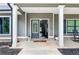 Inviting front entry with double doors, classic columns, and a cozy sitting area at 415 Paynes Lake Rd, Carrollton, GA 30116