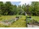 A flourishing garden with raised beds and an arched trellis, perfect for cultivating plants and vegetables at 415 Paynes Lake Rd, Carrollton, GA 30116