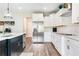 Elegant kitchen with white cabinetry, stainless steel appliances, a subway tile backsplash, and modern fixtures at 415 Paynes Lake Rd, Carrollton, GA 30116