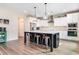Modern kitchen featuring a large center island with seating, stainless appliances, and pendant lighting at 415 Paynes Lake Rd, Carrollton, GA 30116