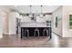 Stylish kitchen featuring white cabinets, stainless steel appliances, an island with bar stools, and wood flooring at 415 Paynes Lake Rd, Carrollton, GA 30116