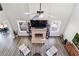 View of a living room with wood floors, a fireplace, a ceiling fan, and large windows at 415 Paynes Lake Rd, Carrollton, GA 30116