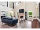 Spacious living room with a soaring ceiling, brick fireplace, and large windows offering picturesque views at 415 Paynes Lake Rd, Carrollton, GA 30116