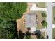 Aerial shot of a home featuring a gray roof, patio with an umbrella, and a long driveway at 4734 Eagles Ridge Loop, Lithonia, GA 30038