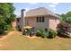 Large backyard with patio, mature trees, and brick and siding house exterior at 4734 Eagles Ridge Loop, Lithonia, GA 30038