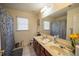Bright bathroom with double vanity, large mirror, and decorative shower curtain at 4734 Eagles Ridge Loop, Lithonia, GA 30038