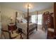 Comfortable bedroom features a bed, window with blinds, and wooden furniture at 4734 Eagles Ridge Loop, Lithonia, GA 30038