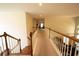 Upstairs hallway featuring wood trim, a neutral color palette, and natural light at 4734 Eagles Ridge Loop, Lithonia, GA 30038