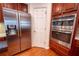 Modern kitchen featuring a stainless-steel refrigerator and stainless double ovens with beautiful wood cabinets at 4734 Eagles Ridge Loop, Lithonia, GA 30038