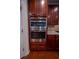 Gourmet kitchen featuring stainless steel double ovens and beautiful dark wood cabinetry at 4734 Eagles Ridge Loop, Lithonia, GA 30038