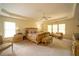 Large bedroom with tray ceiling, three windows, and a ceiling fan at 4734 Eagles Ridge Loop, Lithonia, GA 30038