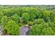 Aerial view of a charming home nestled among lush green trees in a quiet cul-de-sac at 745 Devon Hill Ct, Roswell, GA 30075