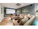 Basement space with plush sectional sofa facing a large screen at 745 Devon Hill Ct, Roswell, GA 30075
