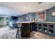 Basement wet bar with bar-style seating and built in cabinets at 745 Devon Hill Ct, Roswell, GA 30075