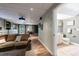Spacious finished basement features a comfortable living area, hardwood floors, and adjacent bathroom at 745 Devon Hill Ct, Roswell, GA 30075