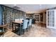 Open basement with dining area, stylish wet bar, and modern lighting at 745 Devon Hill Ct, Roswell, GA 30075