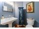Charming powder room with pedestal sink, stylish mirror, and unique decor at 745 Devon Hill Ct, Roswell, GA 30075