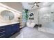 The bright bathroom has a walk-in shower, soaking tub, and stylish vanity; ceiling fan above at 745 Devon Hill Ct, Roswell, GA 30075