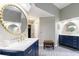 Stylish dual vanity on a marble countertop and round mirrors, set on a grey tile floor at 745 Devon Hill Ct, Roswell, GA 30075
