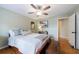 Bedroom featuring light green walls, a ceiling fan, and an entryway into another room at 745 Devon Hill Ct, Roswell, GA 30075
