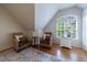 Well lit bedroom featuring windows and hardwood flooring at 745 Devon Hill Ct, Roswell, GA 30075