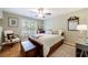 Comfortable bedroom with lots of natural light and a full-size bed, featuring hardwood floors at 745 Devon Hill Ct, Roswell, GA 30075