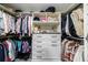 Walk-in closet with custom shelving for clothing and accessories, offering optimal storage at 745 Devon Hill Ct, Roswell, GA 30075