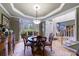 Dining room features stylish lighting, crown molding, and view to the foyer at 745 Devon Hill Ct, Roswell, GA 30075